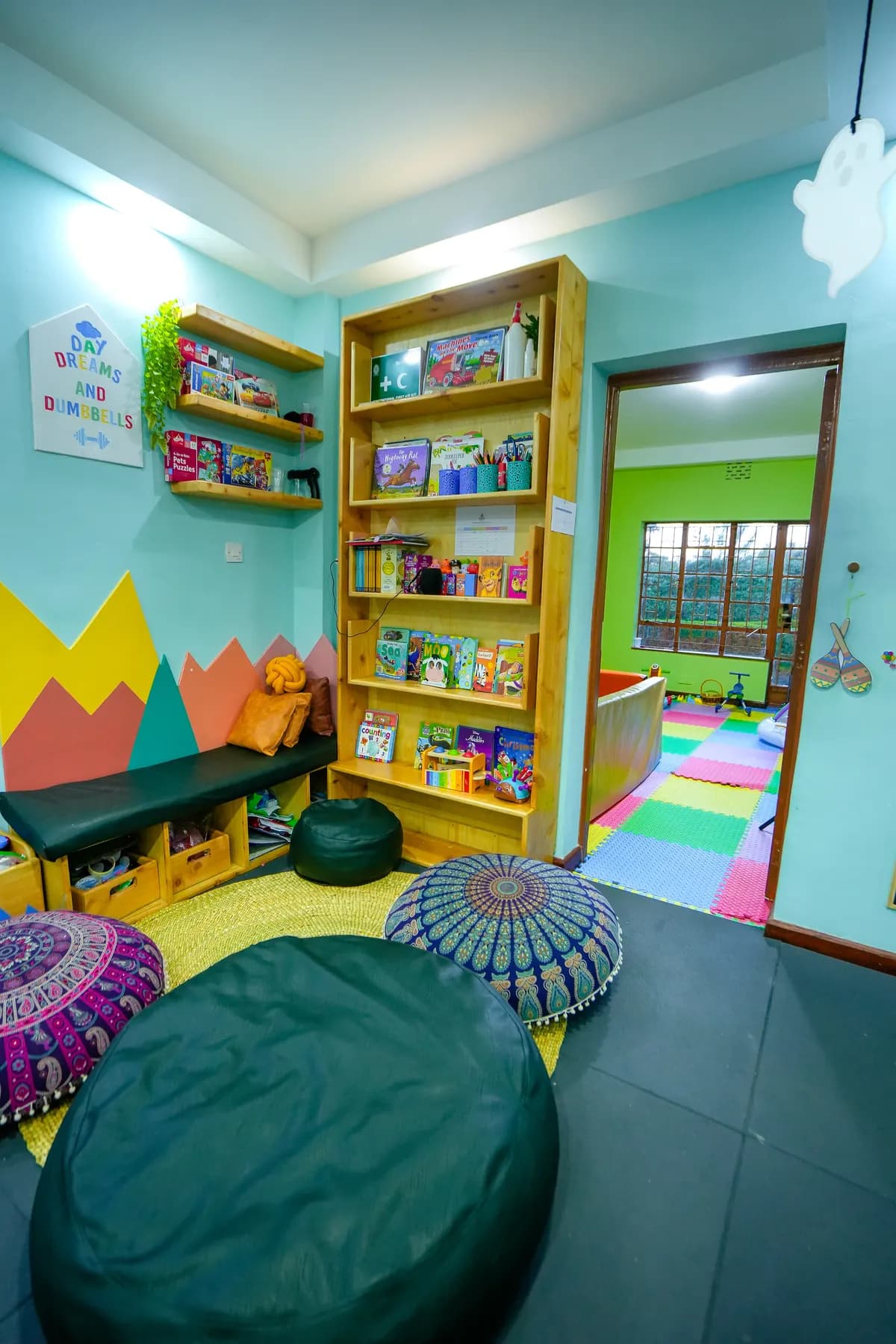 Reading corner with a full bookshelf, cushions and bean bags